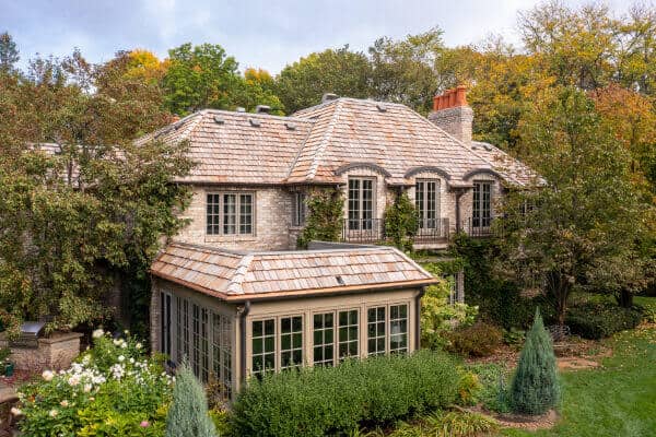 Charming cottage surrounded by lush trees and garden.