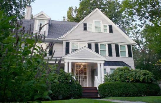 Large white house with green garden