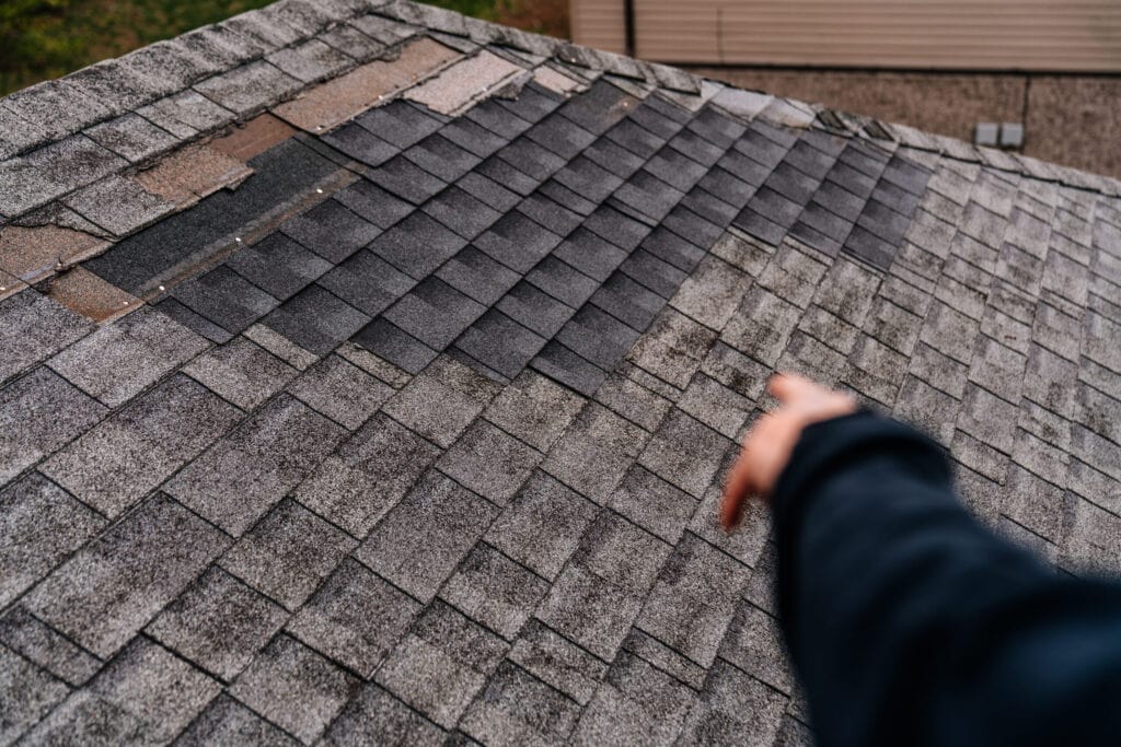 Pointing at damaged roof shingles