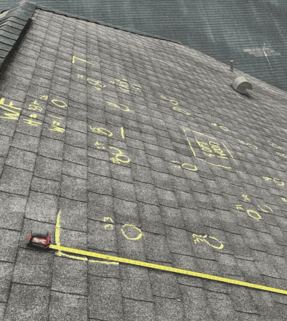 Chalk markings on shingled roof for inspection.