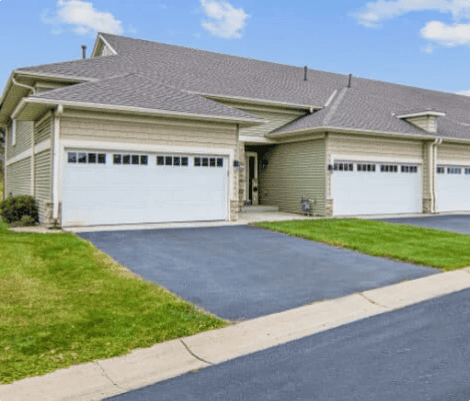 Suburban townhouses with garages and driveways.