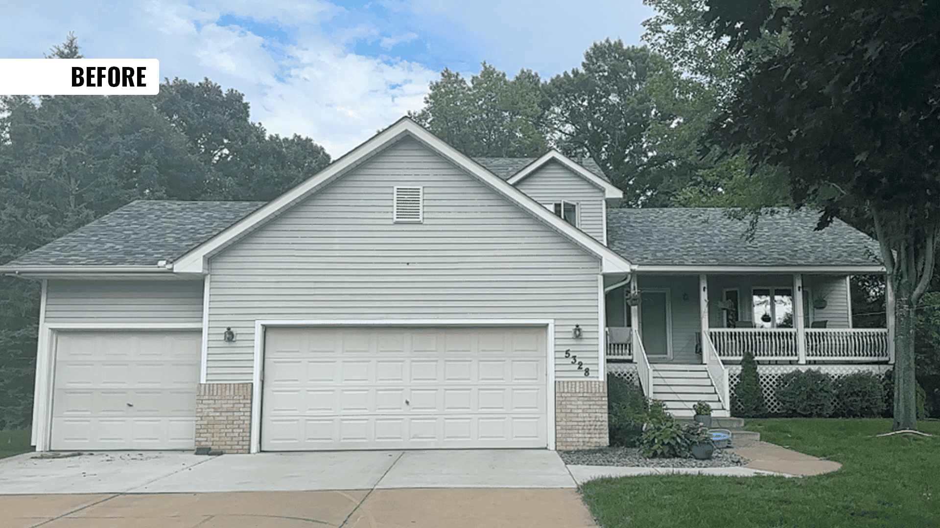 Gray suburban house with front porch and garage