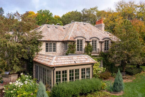 Charming stone cottage with lush garden surroundings.