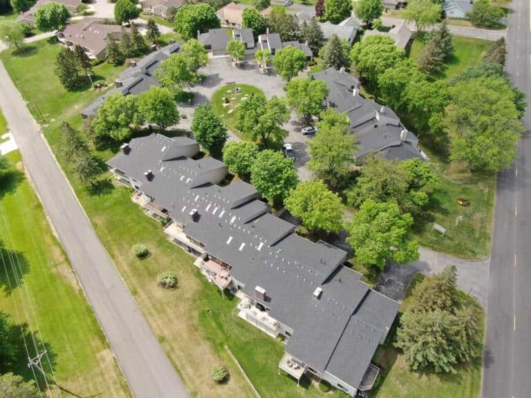 Aerial view of residential neighborhood with trees.