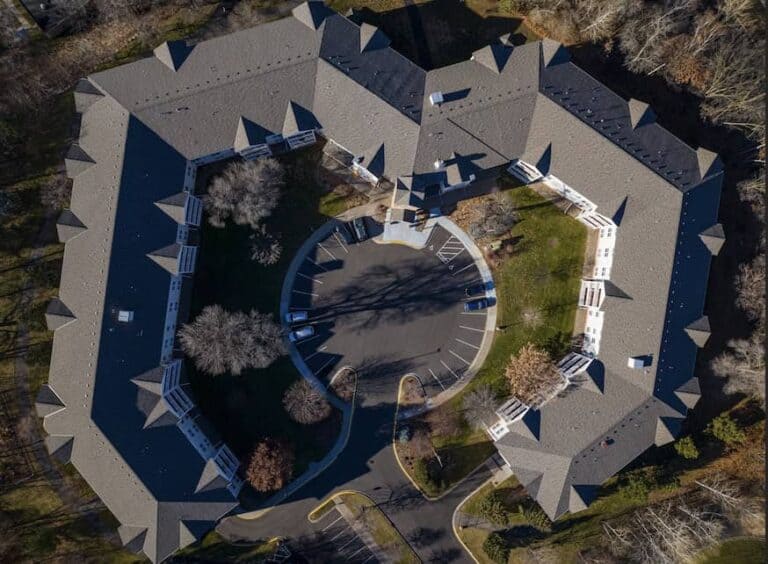 Aerial view of large U-shaped building.