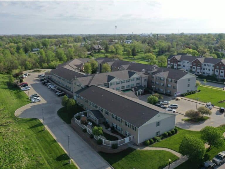 Aerial view of apartment complex surrounded by trees.