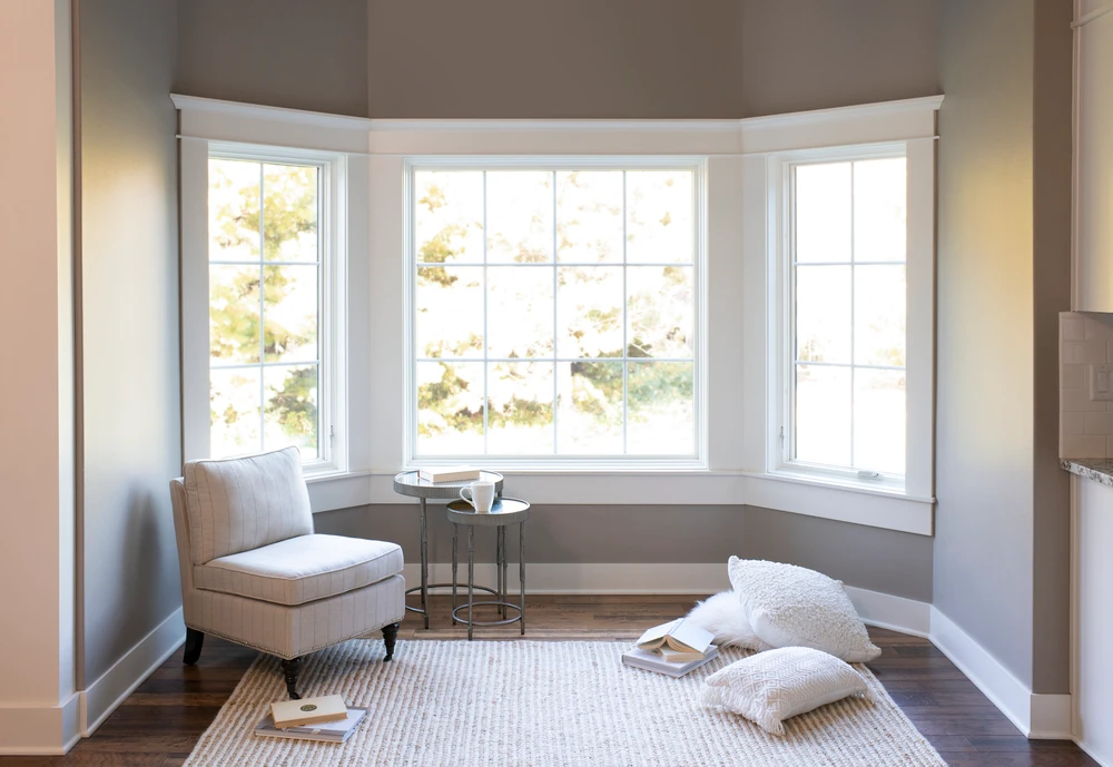 Cozy reading nook with armchair and pillows.