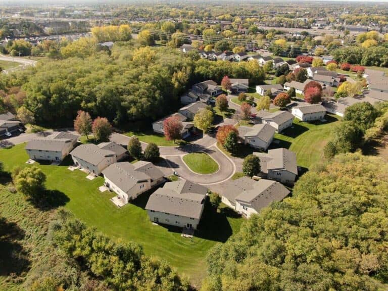 Aerial view of suburban neighborhood with autumn trees.