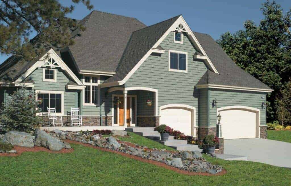 Green suburban house with front yard landscaping.