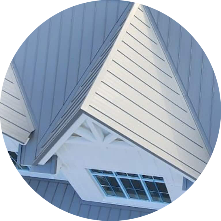 Blue house gable with white trim and window