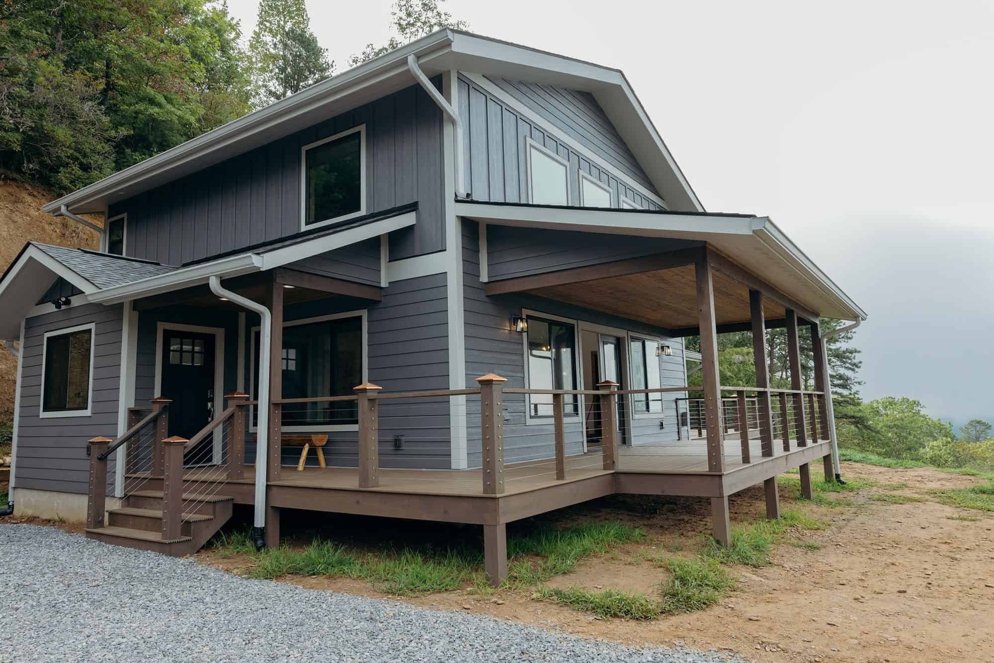 Modern gray two-story house with wraparound porch