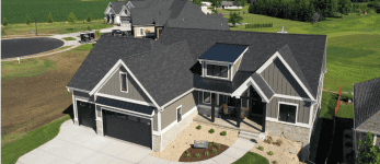 Aerial view of large gray suburban home