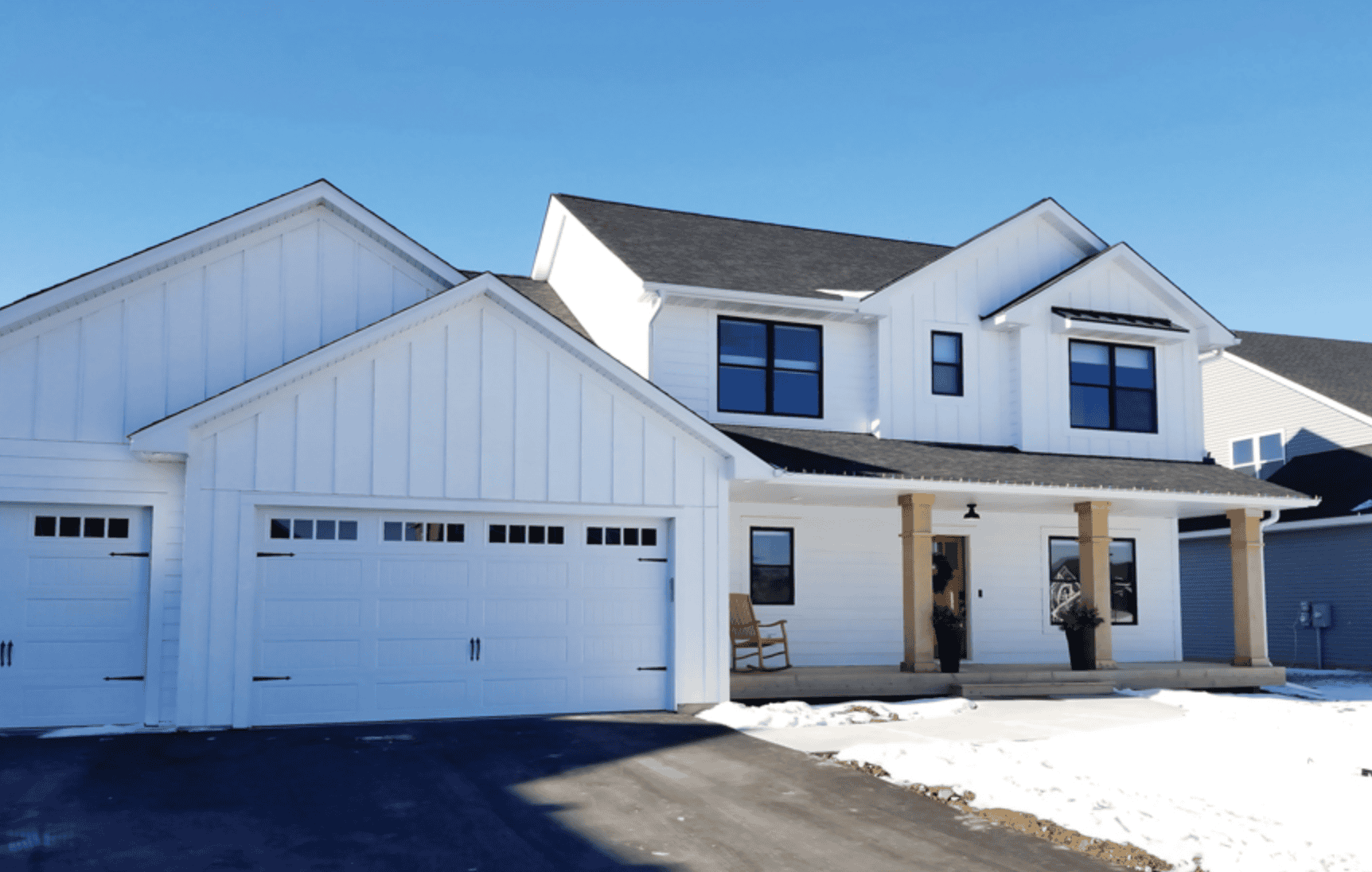Modern white two-story house with attached garage