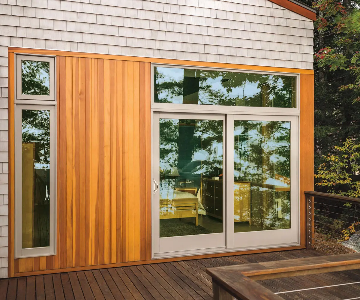 Modern wood-clad exterior with sliding glass doors