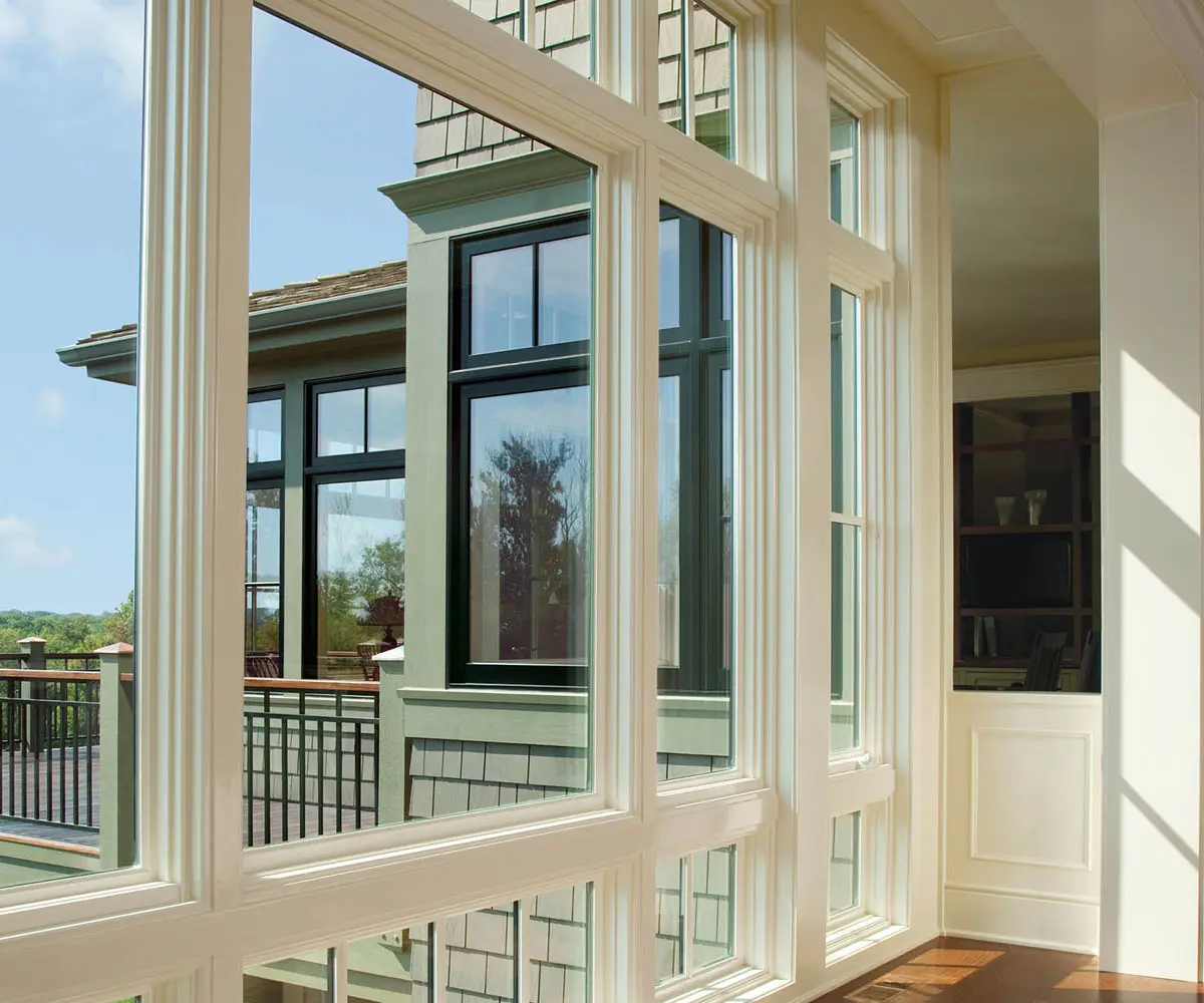 Sunlit white-framed windows overlooking a deck
