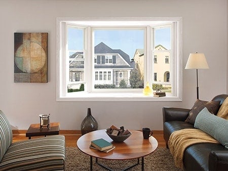 Cozy living room with bay window and neighborhood view